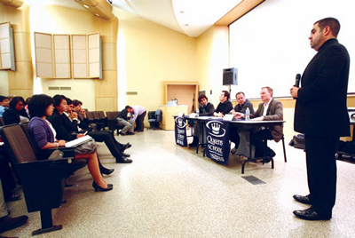 Evan Lamberg, foreground, with panelists, from left, Stephan Moccio, Neil Bearse, James Pertol and Justin Stockman.